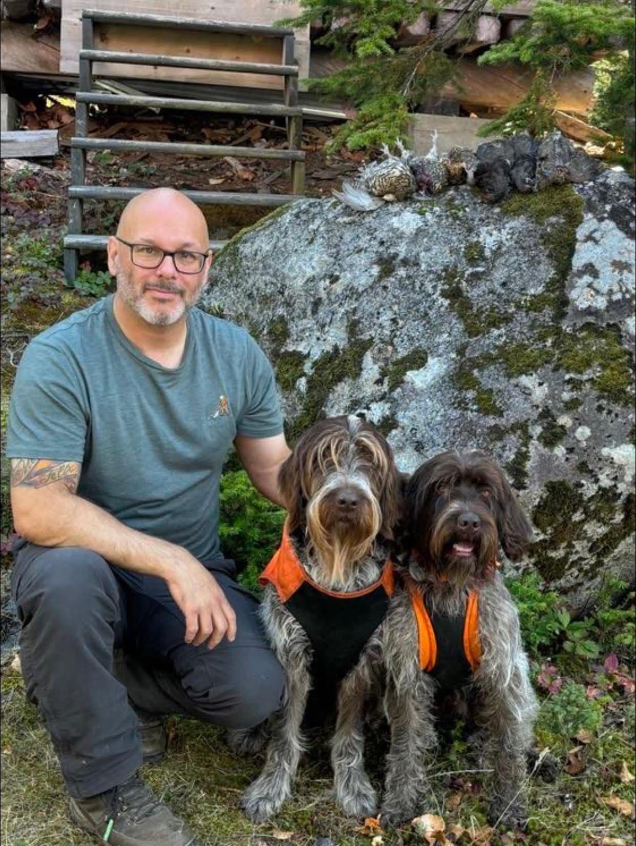 Cinematic portrait of a brown Wirehaired Pointing Griffon between two hunters in an autumn field